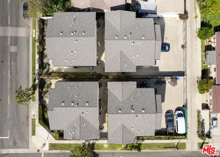 an aerial view of residential houses with outdoor space
