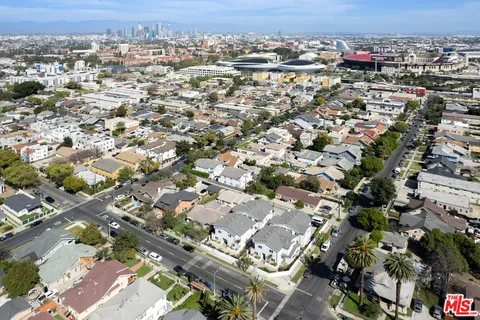 a view of a car parked in front of a white house