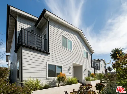 a view of a pathway with a flower garden