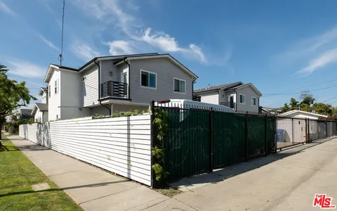 a view of a house with wooden fence
