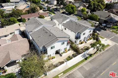 an aerial view of a residential houses with street