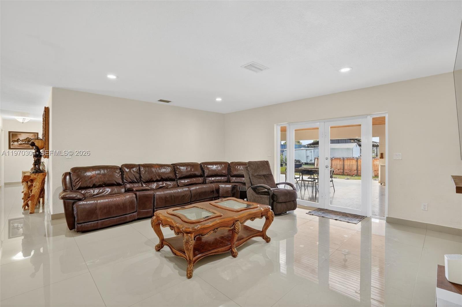 19390 Southwest 312th Street Homestead, FL 33030 - Photo 11 of 44 a living room with furniture and a large window