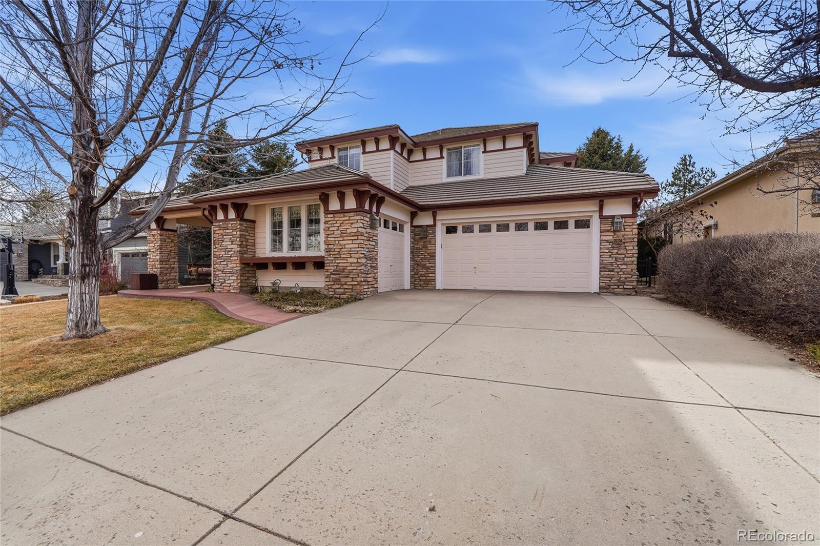8967 Hunters Way Highlands Ranch, CO 80129 - Photo 15 of 50 a front view of a house with a yard