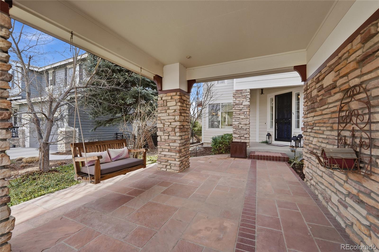 8967 Hunters Way Highlands Ranch, CO 80129 - Photo 16 of 50 a view of a patio with couches table and chairs and potted plants
