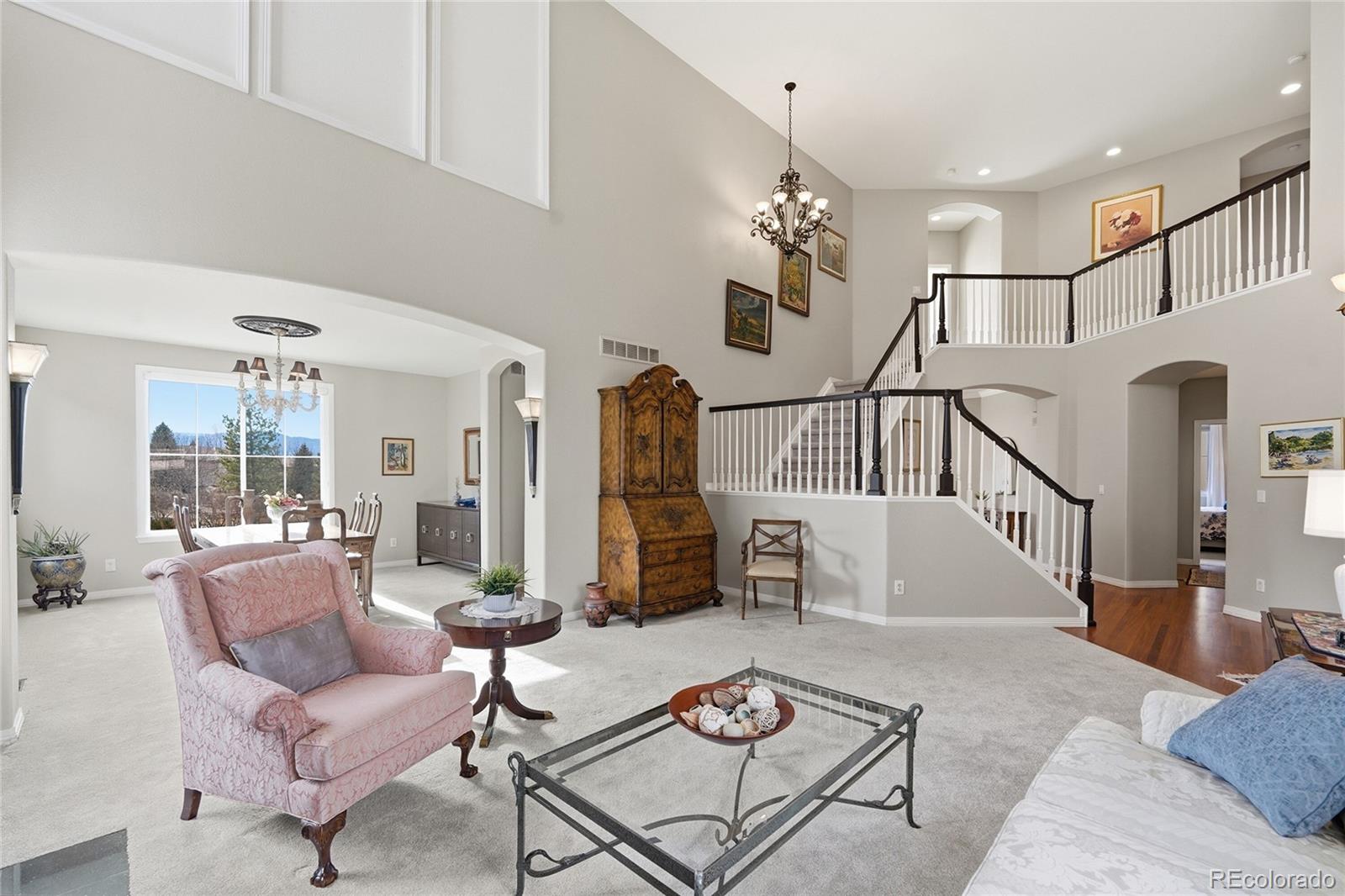 8967 Hunters Way Highlands Ranch, CO 80129 - Photo 18 of 50 a living room with furniture chandelier and a table