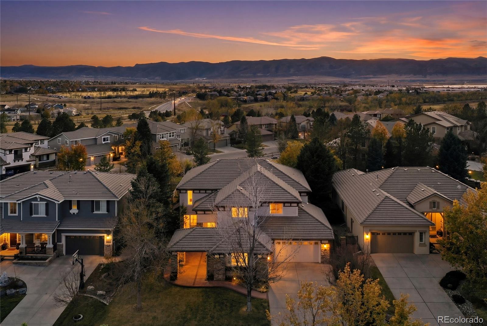 8967 Hunters Way Highlands Ranch, CO 80129 - Photo 2 of 50 an aerial view of multiple houses with a yard