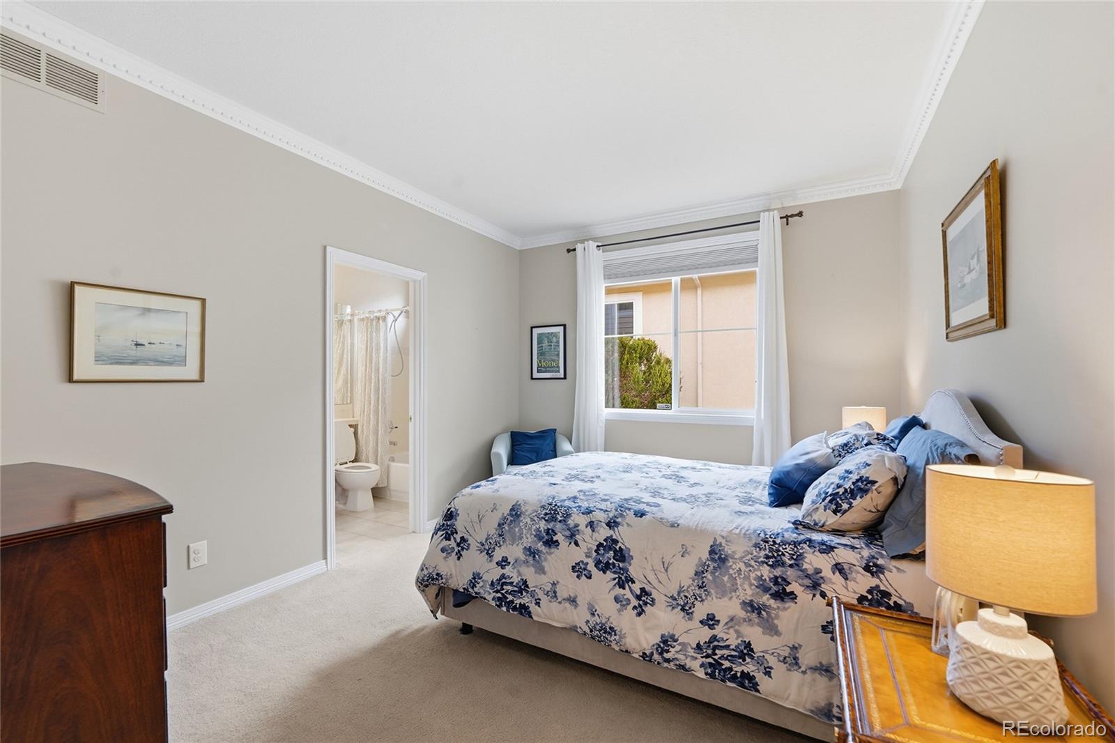 8967 Hunters Way Highlands Ranch, CO 80129 - Photo 24 of 50 a bedroom with a bed and window
