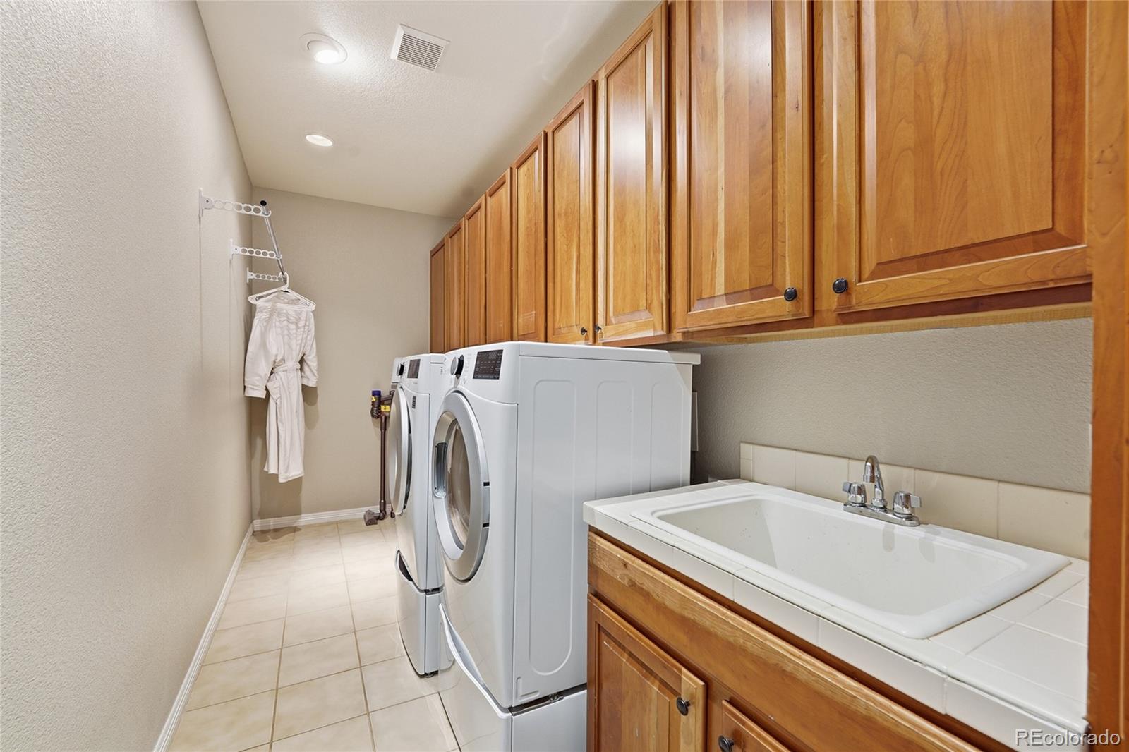 8967 Hunters Way Highlands Ranch, CO 80129 - Photo 26 of 50 a utility room with dryer and washer