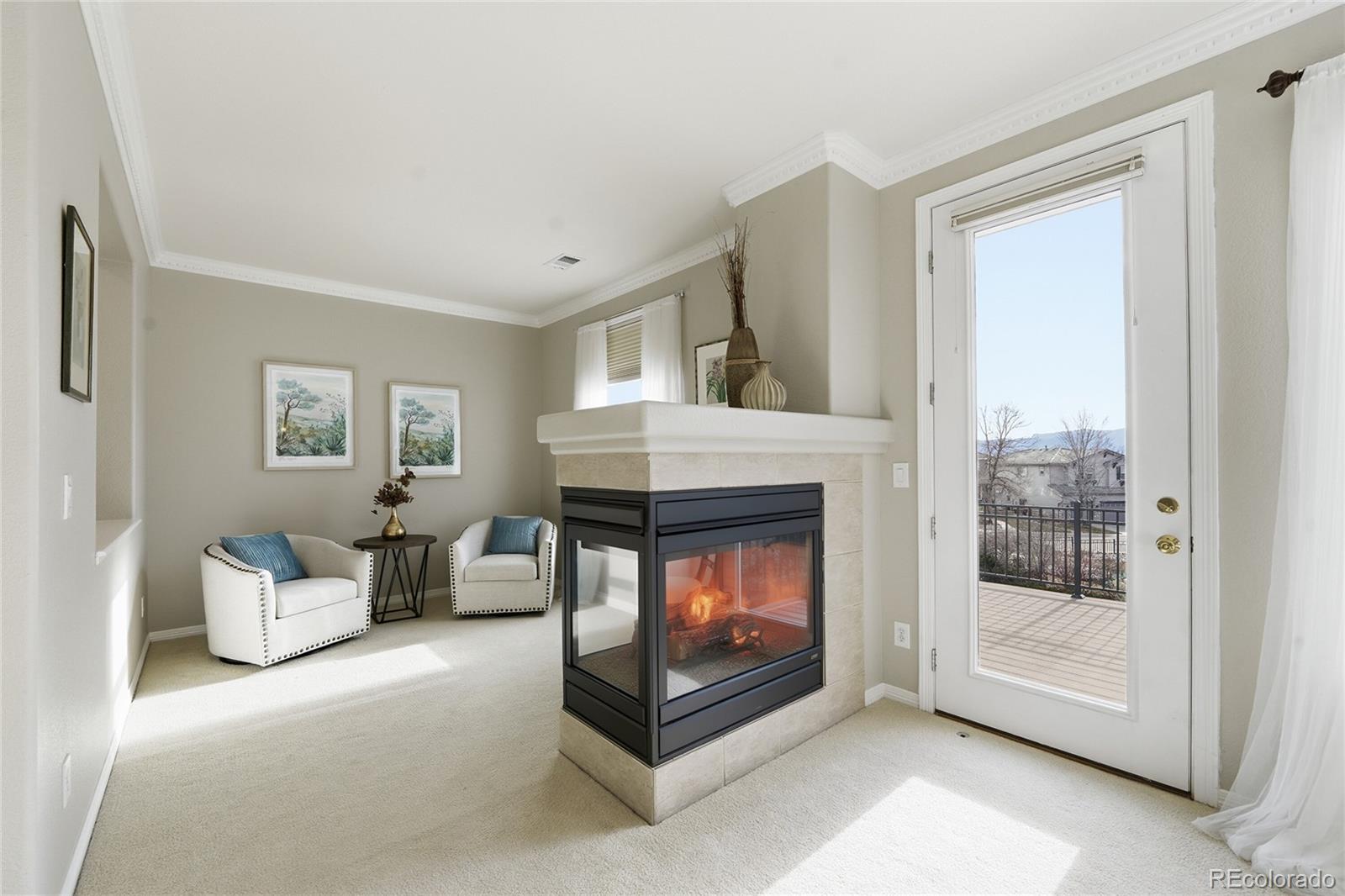 8967 Hunters Way Highlands Ranch, CO 80129 - Photo 28 of 50 a living room with furniture and a fireplace