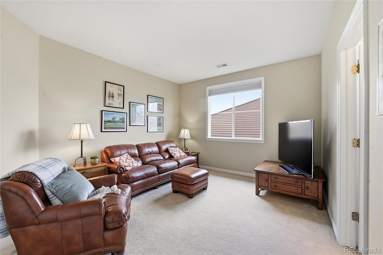 8967 Hunters Way Highlands Ranch, CO 80129 - Photo 36 of 50 a living room with furniture window and a lamp