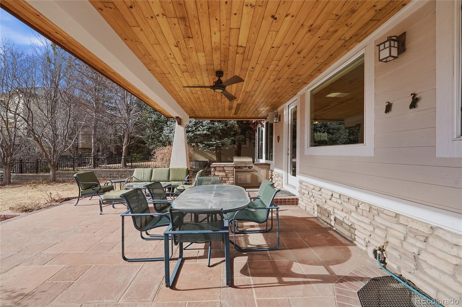 8967 Hunters Way Highlands Ranch, CO 80129 - Photo 38 of 50 a patio with a table and chairs and potted plants