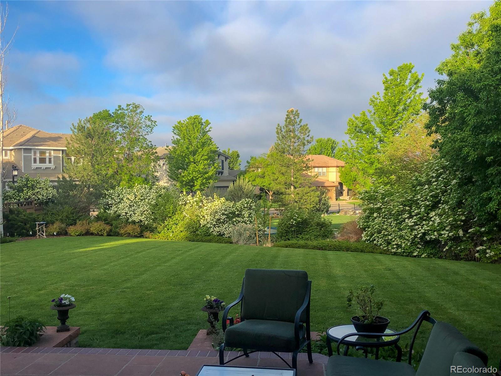 8967 Hunters Way Highlands Ranch, CO 80129 - Photo 41 of 50 a view of a garden with lawn chairs