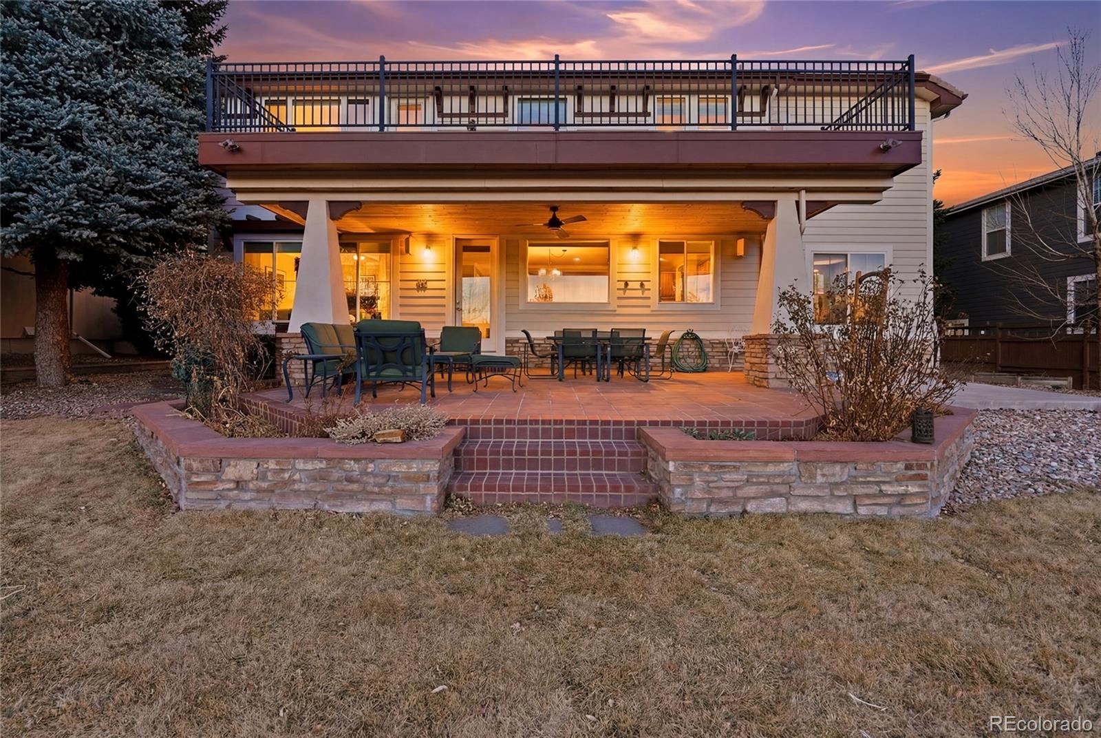 8967 Hunters Way Highlands Ranch, CO 80129 - Photo 44 of 50 a view of a porch with a floor to ceiling window and a table
