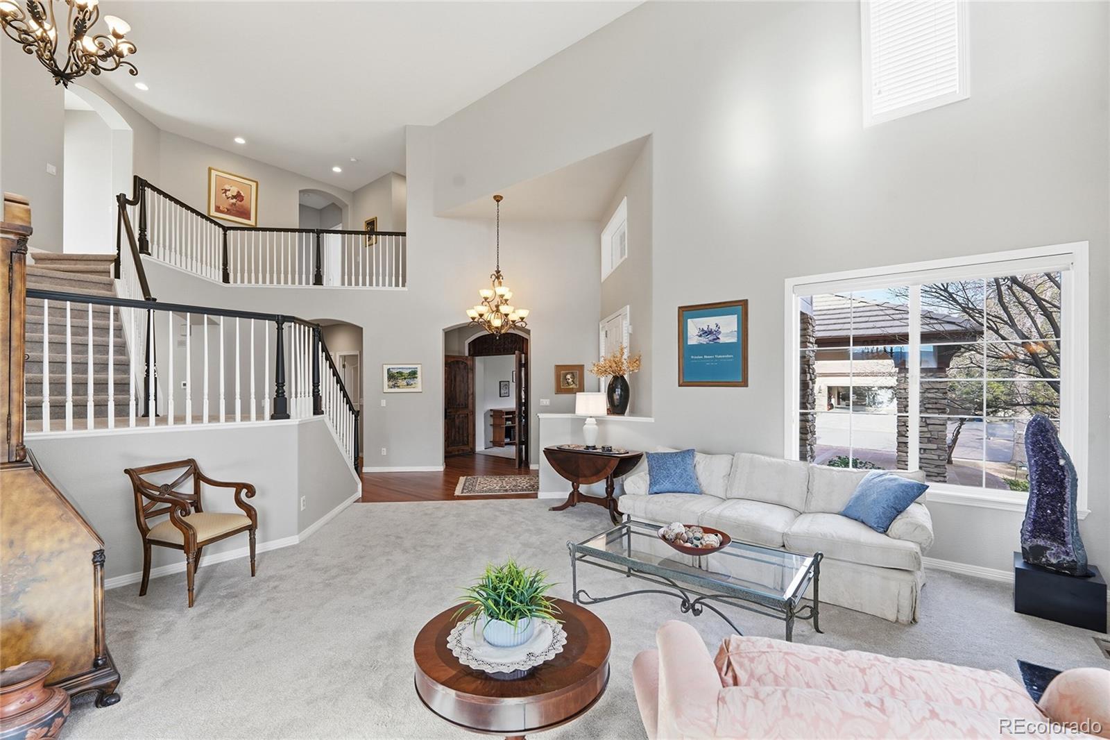 8967 Hunters Way Highlands Ranch, CO 80129 - Photo 5 of 50 a living room with furniture and a potted plant