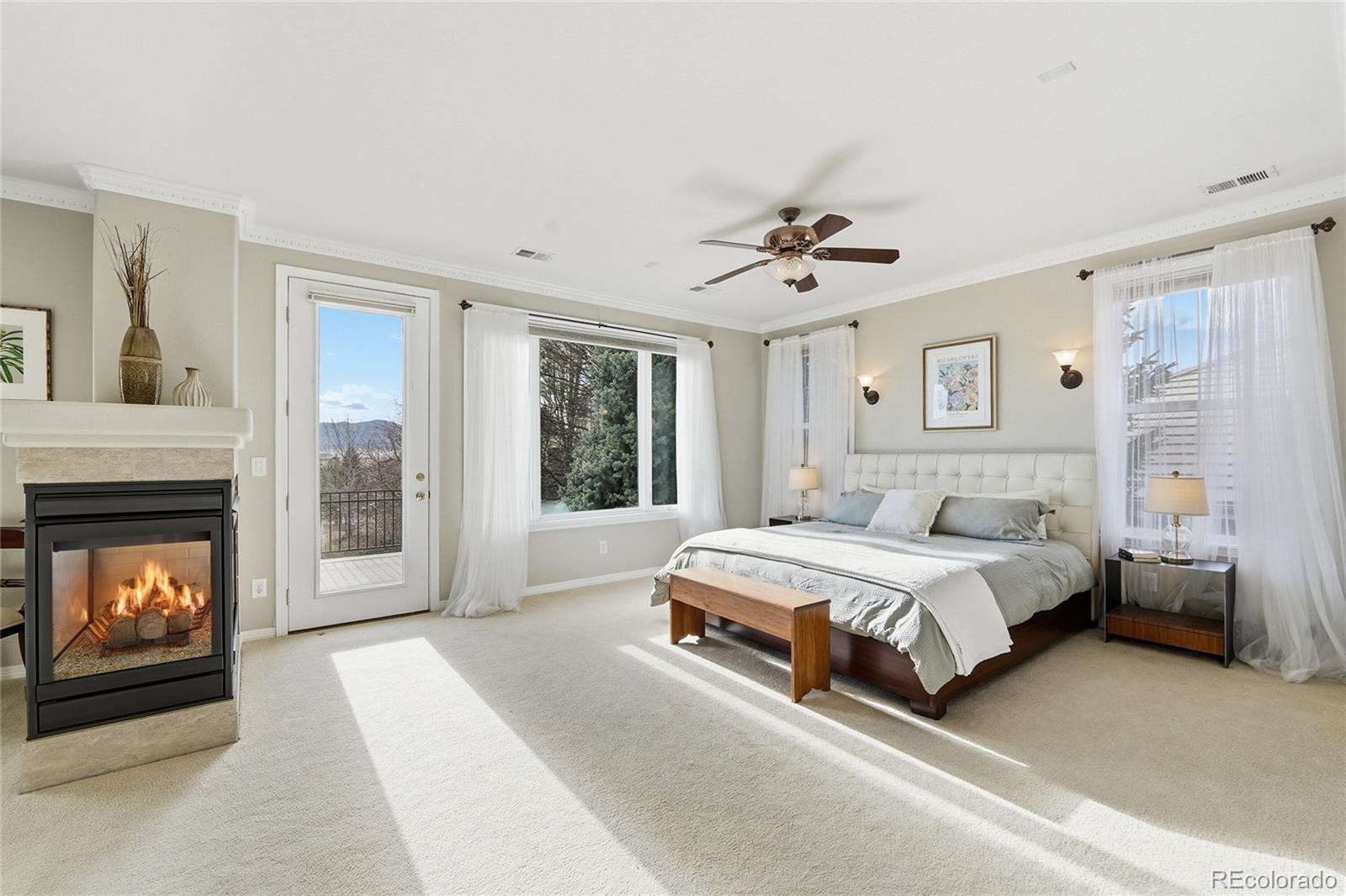 8967 Hunters Way Highlands Ranch, CO 80129 - Photo 6 of 50 a spacious bedroom with a bed and a fireplace