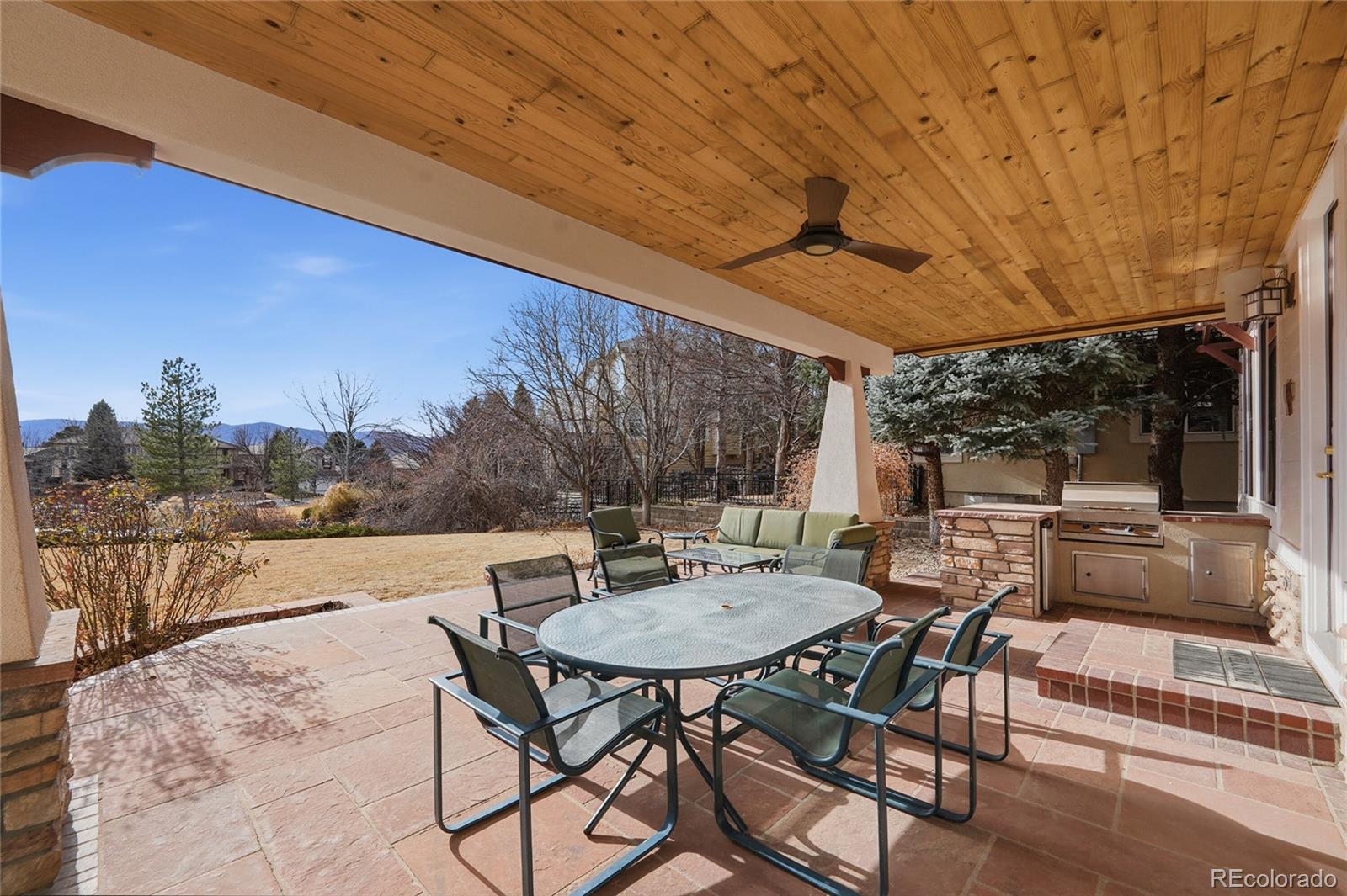 8967 Hunters Way Highlands Ranch, CO 80129 - Photo 10 of 50 a view of a patio with a table and chairs with wooden floor and fence