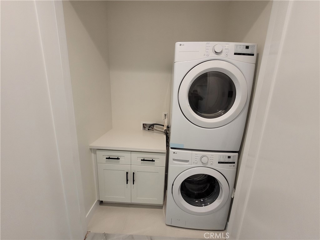 19455 Strathern Street Reseda, CA 91335 - Photo 6 of 11 a utility room with dryer and washer