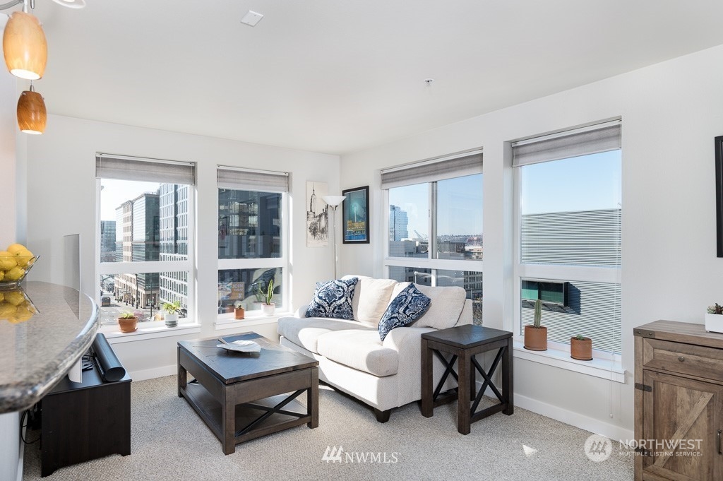 108 5th Avenue South, Unit 402 Seattle, WA 98104 - Photo 1 of 15 a living room with furniture and a fireplace