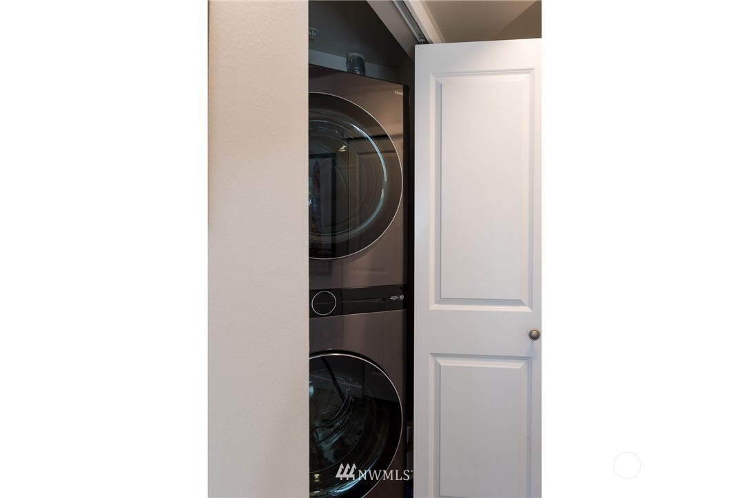 108 5th Avenue South, Unit 402 Seattle, WA 98104 - Photo 12 of 15 a close view of a utility room with dryer and washer