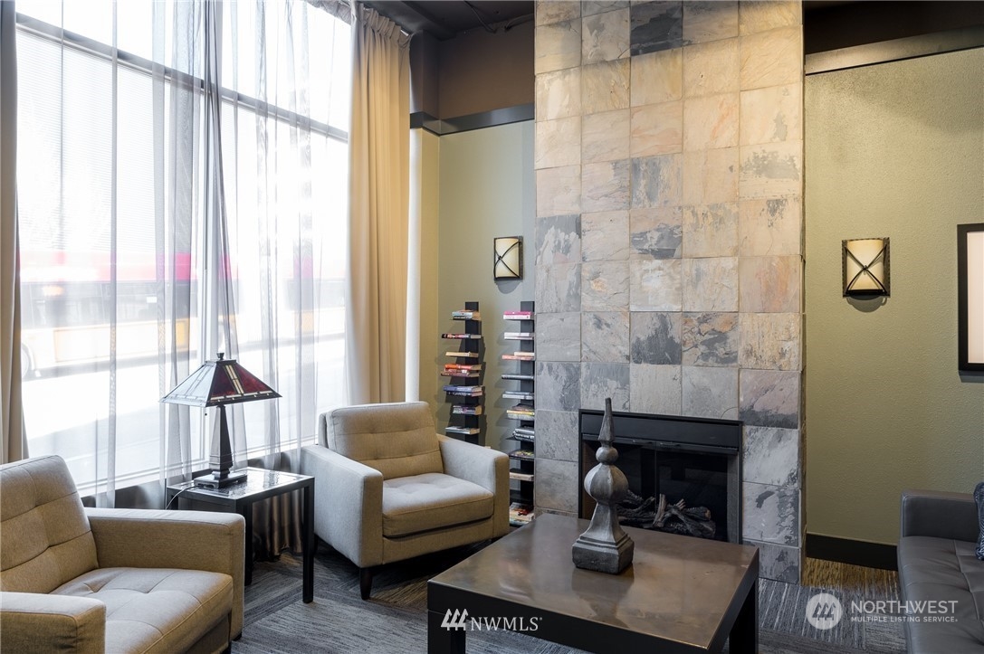 108 5th Avenue South, Unit 402 Seattle, WA 98104 - Photo 14 of 15 a living room with furniture and a fireplace