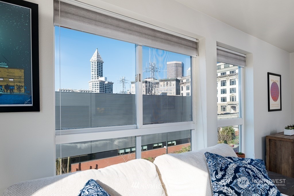 108 5th Avenue South, Unit 402 Seattle, WA 98104 - Photo 2 of 15 a bedroom with a bed and window