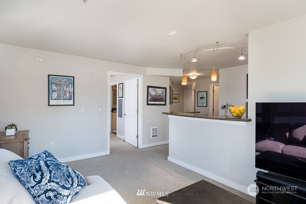 108 5th Avenue South, Unit 402 Seattle, WA 98104 - Photo 3 of 15 a living room with furniture and a wooden floor