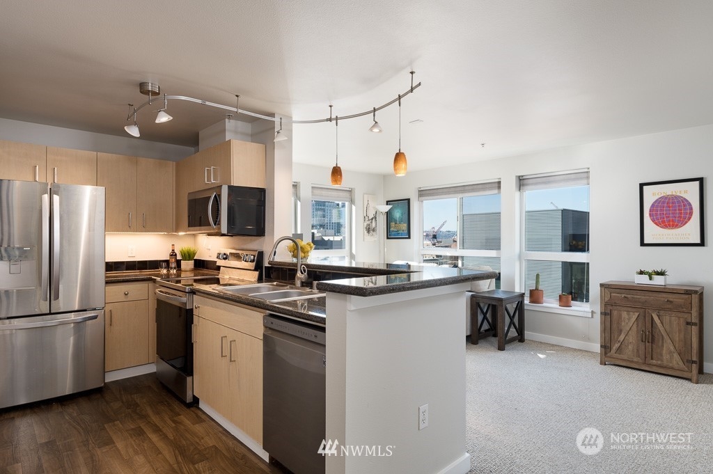 108 5th Avenue South, Unit 402 Seattle, WA 98104 - Photo 6 of 15 a kitchen with cabinets a sink and appliances