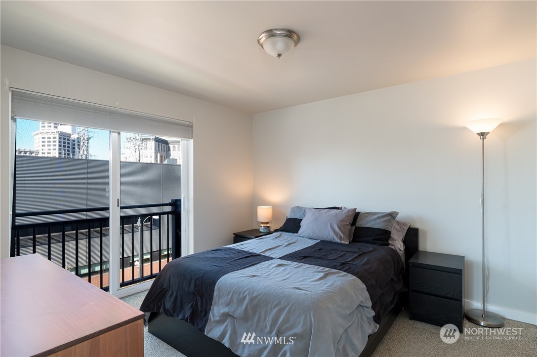 108 5th Avenue South, Unit 402 Seattle, WA 98104 - Photo 8 of 15 a bedroom with a bed and window