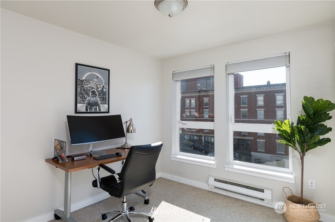 108 5th Avenue South, Unit 402 Seattle, WA 98104 - Photo 9 of 15 a view of a workspace with furniture and a window
