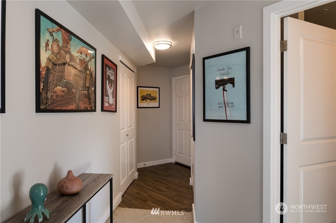 108 5th Avenue South, Unit 402 Seattle, WA 98104 - Photo 10 of 15 a view of a hallway with paintings on the wall