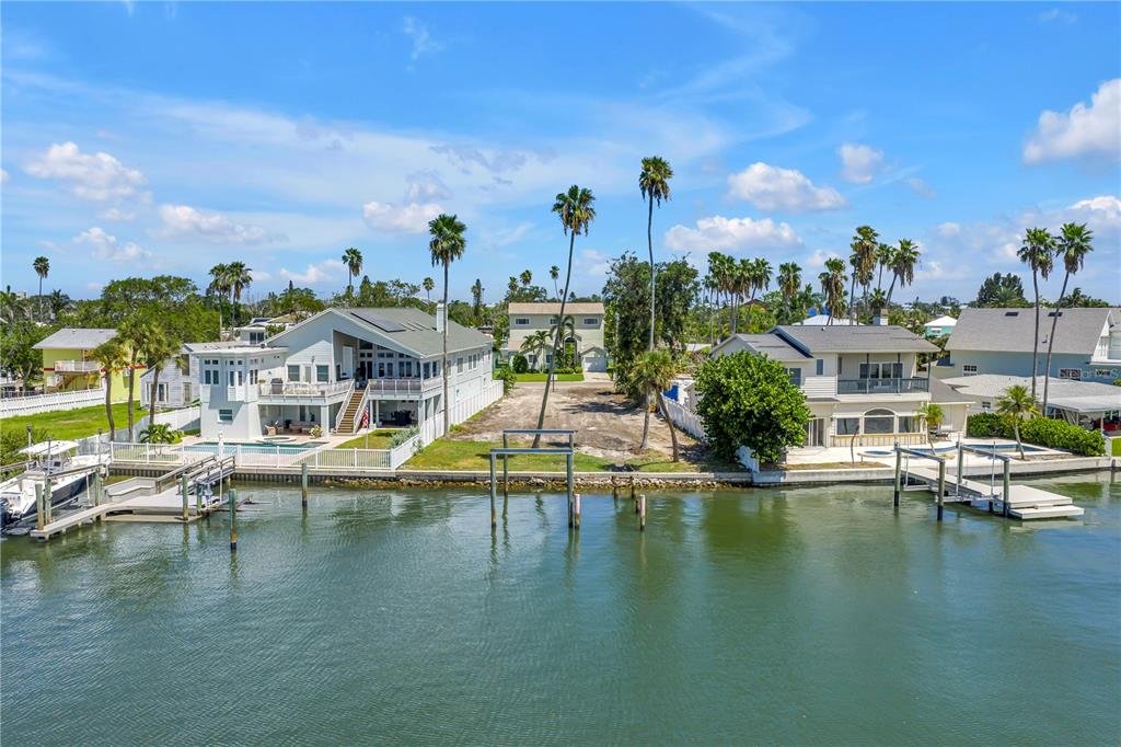 315 10th Avenue North Indian Rocks Beach, FL 33785 - Photo 2 of 13 a view of a lake with a house swimming pool and outdoor space