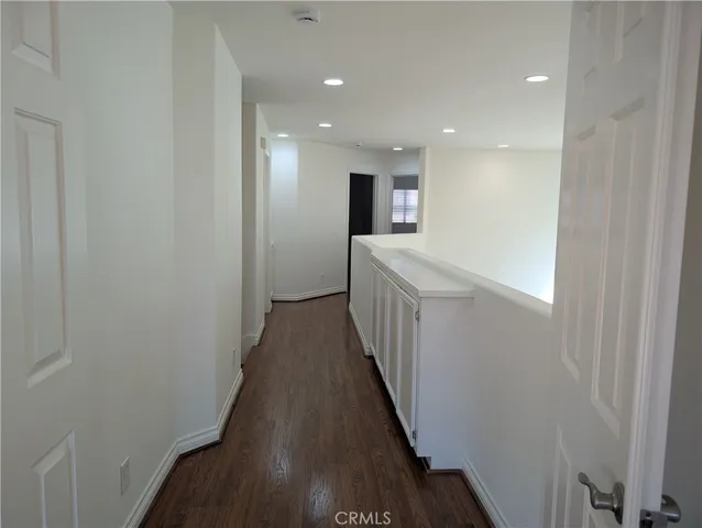 a view of hallway with wooden floor