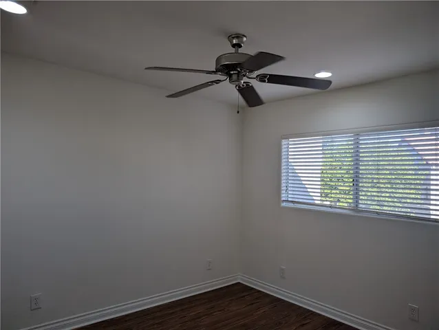 a view of a room with a window and a ceiling fan