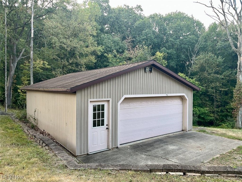 9366 Briar Road Magnolia, OH 44643 - Photo 3 of 25 Detached garage featuring a wooded view