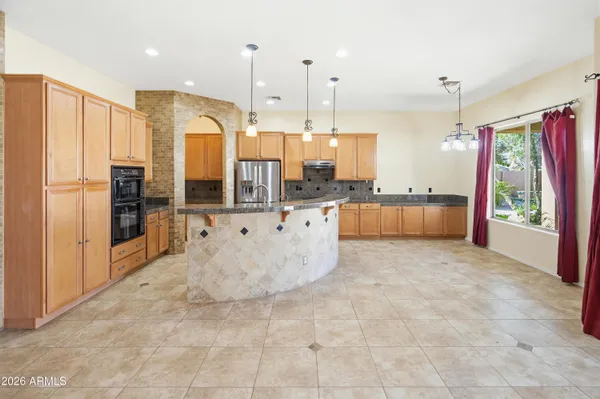 a view of a kitchen with a sink and a fireplace