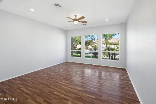 en empty room with white walls and ceiling fan