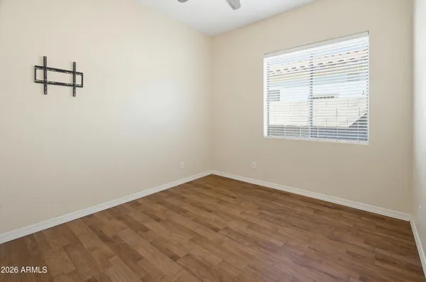 a view of a livingroom with a chandelier wooden floor and windows