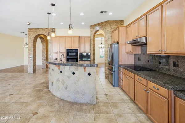 a view of a white house with a big yard and large trees