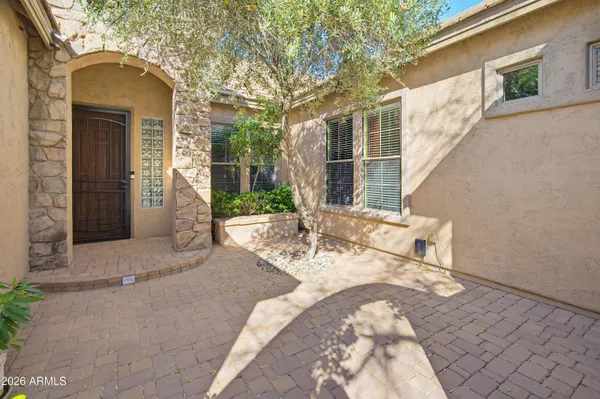 a view of a house with backyard and tree