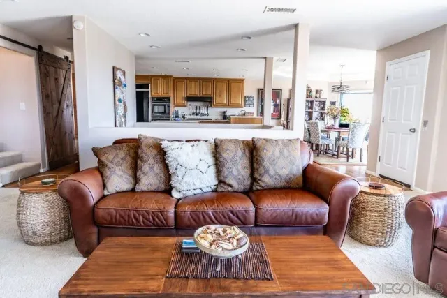 a living room with furniture and a rug