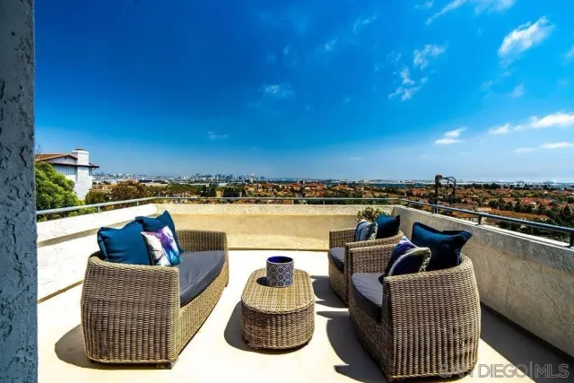 a view of a lake with couches chairs