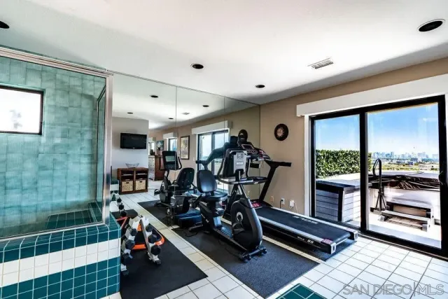 a living room with furniture a fireplace and a large window