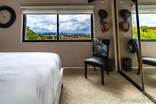 a bedroom with a bed and a large window