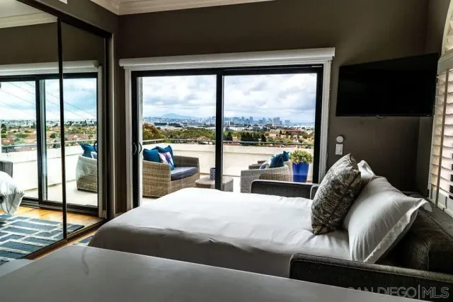 a bedroom with a bed and a large window