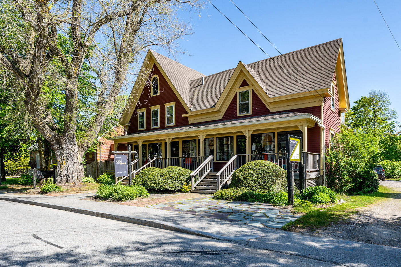 354 Main Street Wellfleet, MA 02667 - Photo 1 of 40 a view of a brick house with a yard plants and large tree