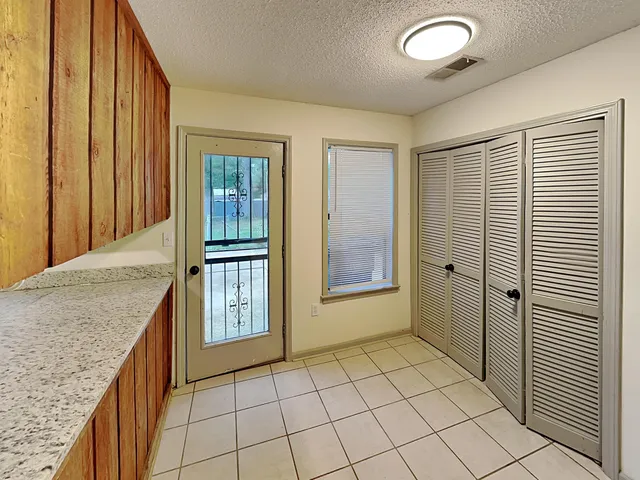 a large kitchen with a sink and large stainless steel appliances