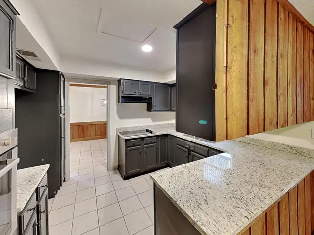a view of a hallway with wooden shelves