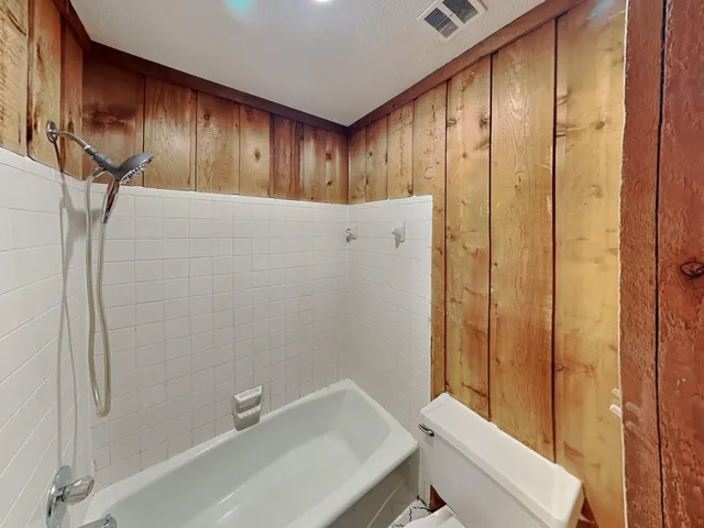 a bathroom with a granite countertop sink mirror and shower