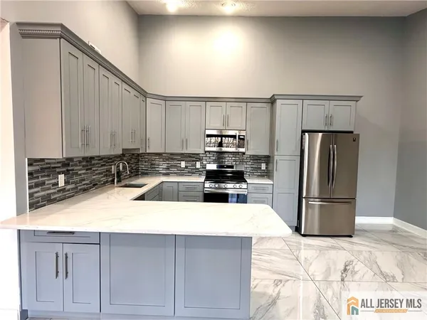 a kitchen with a refrigerator sink and cabinets