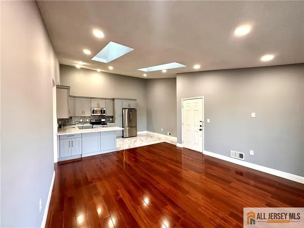 a open kitchen with kitchen island a sink stainless steel appliances and cabinets